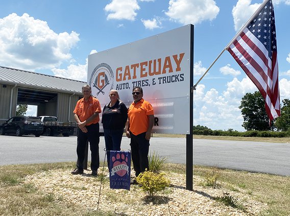 Tabatha Anderson, center, stands with Ricky Pearson, left, and Ricky Espinoza at at Gateway Auto, Tires & Trucks.