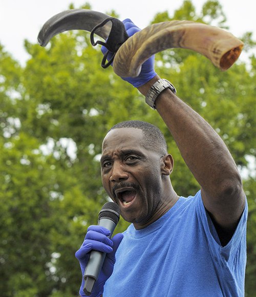 Bishop Larry Jones of Whitesville Full Gospel Church prepares to blast a shofar to usher in Rosh Hashana and demonstrate his belief in the unity of all people as children of the one true God during the Justice Caravan for Julian Lewis in Sylvania on Saturday
