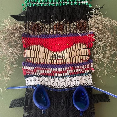 The totems incorporate unexpected items into the weaving.