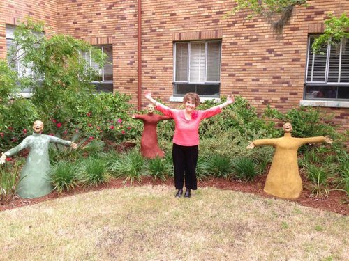 Virginia Holliday, one of the Elderberries, with sculptures in Asbury's garden.
