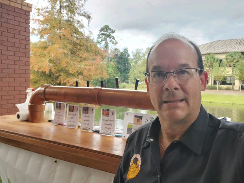 Chris Stovall standing in front of the SBL Portable bar. A 6 tap bar built to share members kegged homebrews at SBL events