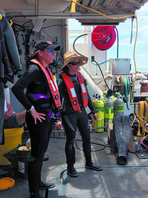 Chief scientist Kim Roberson (left) oversees operations and makes twice daily dives to collect data and specimens.