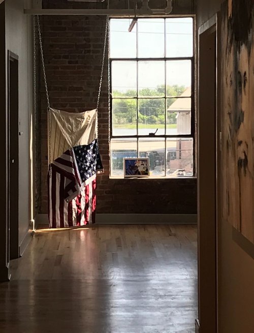 5. Untitled (Skinned), Installation view, variable, United States flags, bleach, sinew, chain, 2017