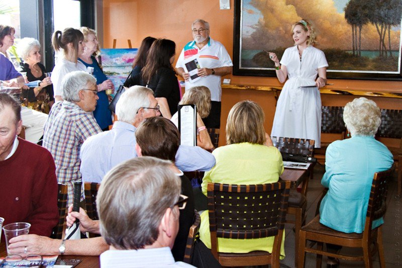 Tiffani Taylor welcomes guests to the Art Walk at Rocks on the Roof with wine pour provided by Bohemian Riverfront Hotel.