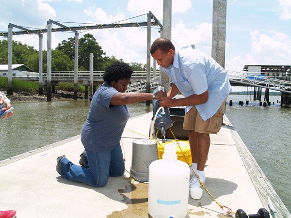 Skidaway Institute’s LaGina Frazier and Kevin McKenzie transfer a water sample from a collection bottle to plastic storage jug.