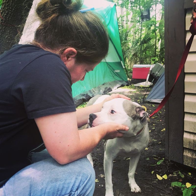 Coastal Pet Rescue Founder/Director Lisa Scarbrough with a friend in one of the camps.