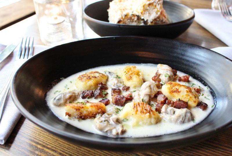 Beau Soleil oysters from New Brunswick, thick-cut house-cured bacon and homemade potato gnocchi bathe in a light vermouth cream sauce and are finished with sweet pecan oil.