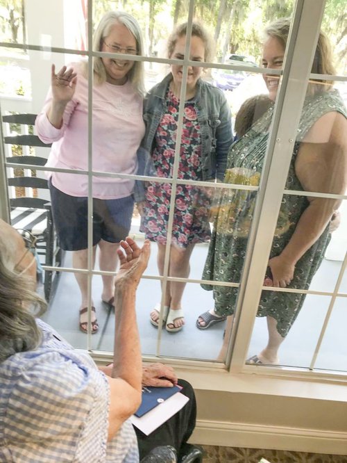 Emily Calhoun visiting her mom through a window.