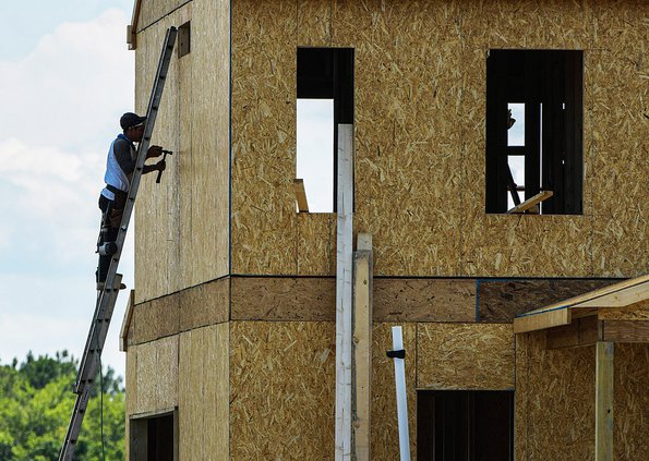 A worker helps construct a building at Keystone Homes at Chatham Place on Wednesday, June 23. Private developers are planning and developing residential subdivisions at a near-record pace in Bulloch County, while shortages and skyrocketing prices of build