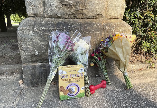This photo shows a memorial at the Piedmont Park, Wednesday, July 28, 2021 in Atlanta. Authorities are searching for the person who fatally stabbed a woman who was walking her dog in Piedmont Park, one of Atlanta's most popular parks. Katherine Janness, 4