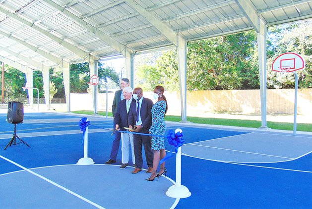 City and county elected officials, left to right, Statesboro District 1 Councilman Phil Boyum, Bulloch County Commissioners Chair Roy Thompson, Statesboro Mayor Jonathan McCollar and District 2 Councilwoman Paulette Chavers line up at the ceremonial ribbo