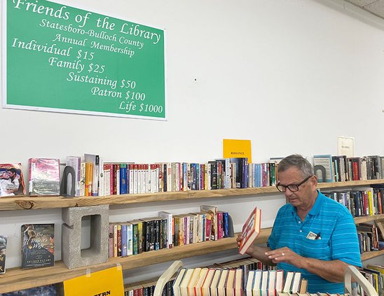 Walt Strickland, a board member with the Friends of the Statesboro-Bulloch County Library, shelves some of the books that will be for dale with the Friends of the Library opens their used bookstore Friday.