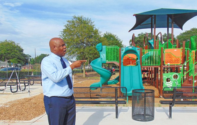 Mayor Jonathan McCollar, photographed while describing new features of Luetta Moore Park before it reopened July 31, says the $4.5 million park renovations the city of Statesboro undertook this year with the county's cooperation are just one example of "l