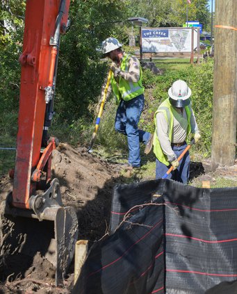 Workers in Georgia Power hardhats are seen doing excavation in the Blue Mile area of South Main Street last week. All power and telecommunications lines immediately to the east of the street are being placed underground as part of the streetscape plan.