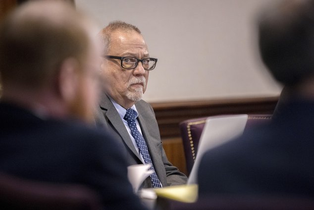 Greg McMichael, center, listens to arguments during the trial of himself, his son Travis McMichael, and a neighbor, William "Roddie" Bryan in the Glynn County Courthouse, Tuesday, Nov. 9, 2021, in Brunswick, Ga. The three are charged with the February 202