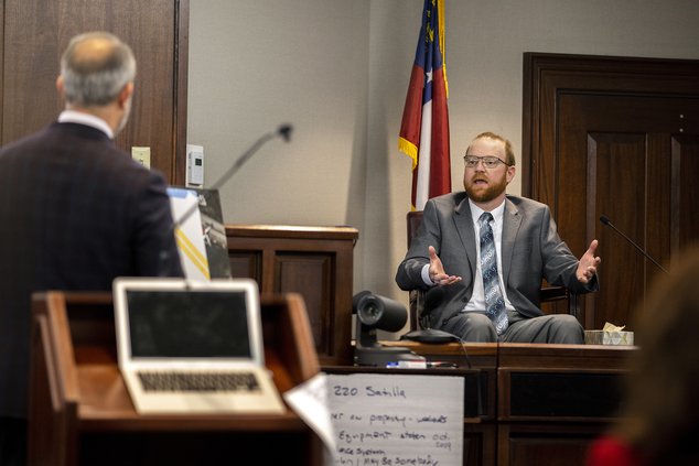 Travis McMichael reacts to questions during his testimony in the trial of he and his father Greg McMichael and neighbor William "Roddie" Bryan in the Glynn County Courthouse, Wednesday, Nov. 17, 2021, in Brunswick, Ga. The three are charged with the Febru