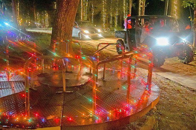 The old merry-go-round from Fair Road Park is one of the newer features at TMT Farms for the annual Christmas light show to raise money and distribute food donations that opened Thanksgiving night.