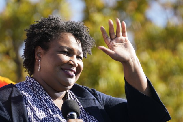 Stacey Abrams speaks to Biden supporters as they wait for former President Barack Obama to arrive and speak at a campaign rally for Biden at Turner Field in Atlanta, Nov. 2, 2020.