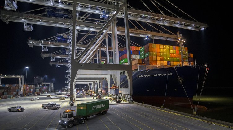 Five ship to shore cranes and gangs of longshoremen work to load and unload the container ship CMA CGM Laperouse at the Georgia Ports Authority's Port of Savannah, Sept. 29, 2021, in Savannah, Ga. The Port of Savannah has added another month to its streak