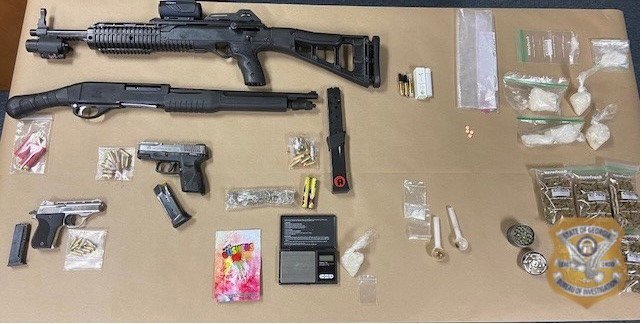 Shown are some of the weapons and drugs seized after a search warrant yielded the arrests of 4 Emmanuel County residents.