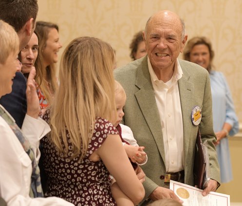 Doug Lambert, right, greets his family after being named the 2022 Citizen of the Year by the Statesboro Rotary Clubs at Forest Heights Country Club on Wednesday, March 23.