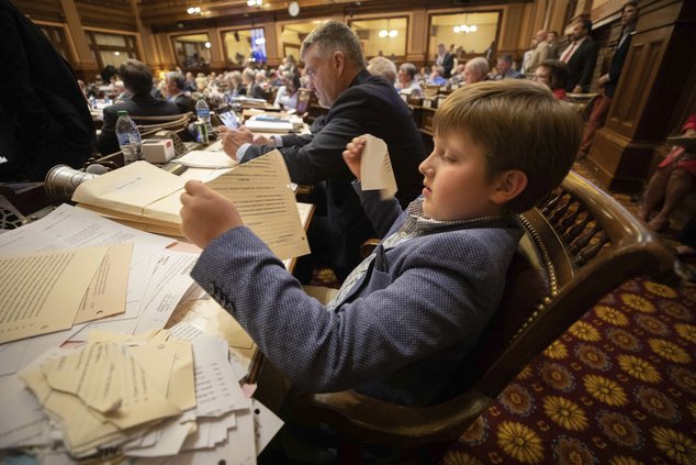 John William, 8, tears up paper before the conclusion of the legislative session on Sine Die, the last day of the General Assembly at the Georgia State Capitol in Atlanta on Monday, April 4, 2022.