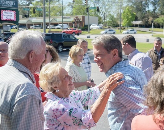 Hosts Raybon and Janelle Anderson, left, greet Governor Brian Kemp during  campaign stop at Anderson's General Store on Friday, April 15.