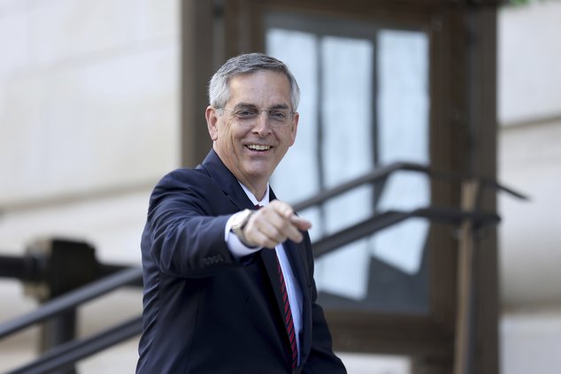 Georgia Secretary of State Brad Raffensperger reacts to members of the media as he enters the Fulton County Courthouse to testify to a grand jury involving the probe into whether former President Donald Trump and others tried to improperly overturn the 20