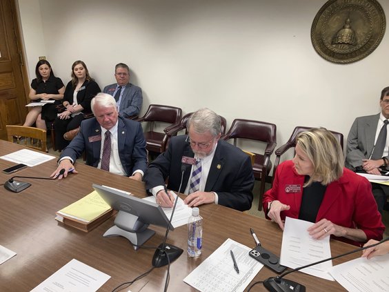 Georgia House Appropriations Committee Chairman Terry England, center, signs his final budget on Monday, April 4, 2022, at the state capitol in Atlanta. England, R-Auburn, is retiring after 12 years as the House's chief budget writer.