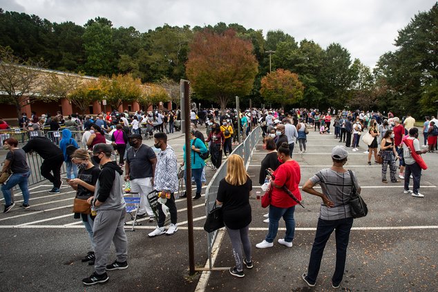 Hundreds of people wait in line for early voting on Oct. 12, 2020, in Marietta, Ga. State Election Board member Matt Mashburn testified at a hearing on Monday, July 18, 2022, that conduct he witnessed at this polling place led him to conclude it was neces