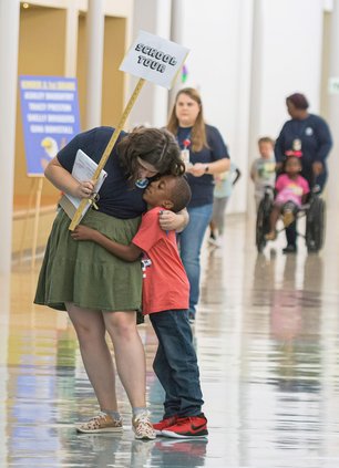 Mattie Lively Elementary School second grade teacher Macy Tankersley gets a big hug from student Tristan Gordan, 7, during a school tour on the first day of the new school year on Monday, August 1.