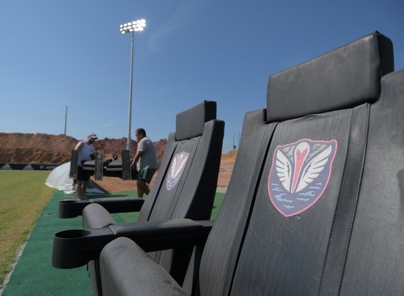 ABOVE, Tormenta FC Digital Media and Engagement Coordinator Brian Evans, left, and Public Relations Coordinator Edwin Pintor move chairs into the team bench areas on Monday, Sept. 26 as the team's staff prepares to host the first game at their new home fi