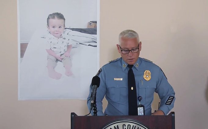Chatham County Police Chief Jeff Hadley speaks to reporters as he stands in front of a large photo of missing toddler Quinton Simon at a police operations center being used in the search for the boy's remains just outside Savannah, Ga., Tuesday, Oct. 18,