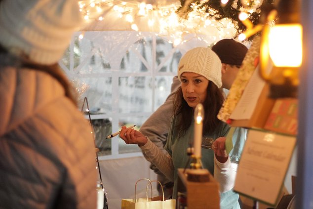 In the glow of lantern and candle light, Stacie Anderson fills orders for her Overbrook Farm Scented Candles products during the Shopping By Lantern Light event in 2021. The 2022 Lantern Light event is set for Tuesday, Nov. 22.