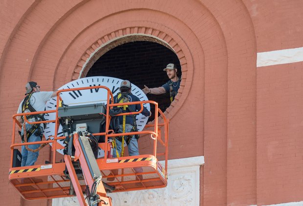 A Whitfield Sign Company crew hoists a new clock face into the Bulloch County Courthouse clock tower on Wednesday, Jan. 11.