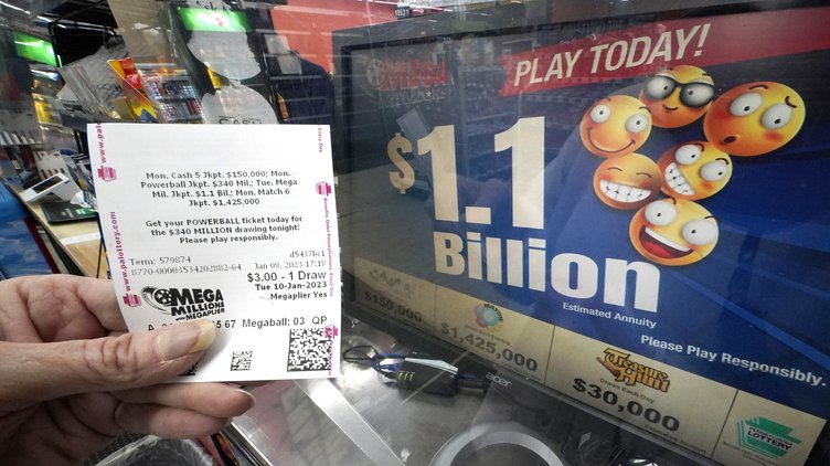 A Mega Millions customer purchases her tickets for the estimated jackpot of $1.1 Billion at the Fuel On Convenience Store in Pittsburgh, Monday, Jan. 9, 2023.