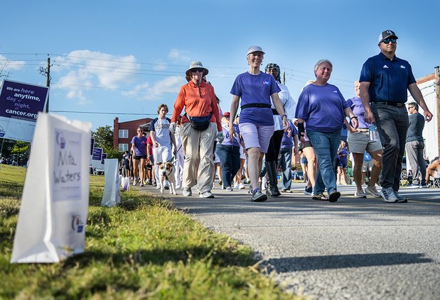 SCOTT BRYANT/Herald File During the 2022 Relay for Life, Cancer survivors Laurie Cigal, center, Lori Wiggins, center right, lead the way escorted by Georgia Southern football coach Clay Helton, right, during the ceremonial Survivors Walk to kick off the e