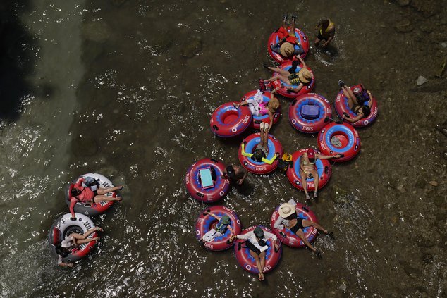 Tubers float the cool Comal River in New Braunfels, Texas, Thursday, June 29, 2023. The entire planet sweltered for the two unofficial hottest days in human recordkeeping Monday and Tuesday, according to University of Maine scientists at the Climate Reana
