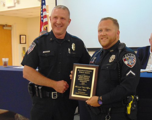 Statesboro Police Department Advanced Patrol Officer Arion Waters, right, receives a Meritorious Service Award presented by SPD Deputy Chief Rob Bryan, left.