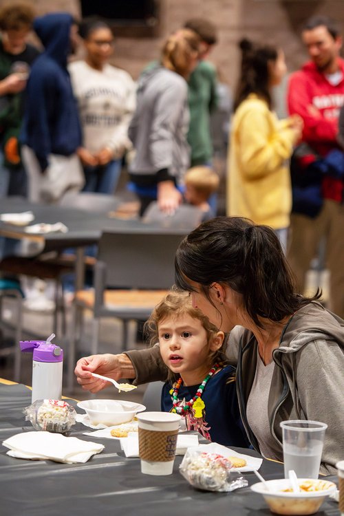 Emma Bohler, 3, gets a bite of chicken soup from mom Lori at the Williams Center following the official Lighting of Sweetheart Circle. Guests enjoyed hot soup and chili, as well as some sweet holiday treats.