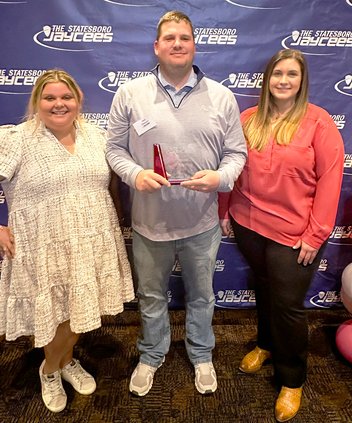 Matt LaTulip, center, was named Jaycee of the Year. He is shown accepting the award.