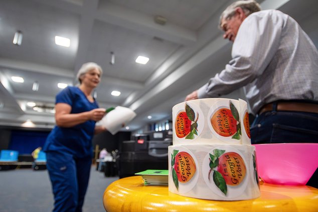 Poll worker Steve Healy, right, welcomes Barbara Taylor as she prepares to cast her ballot at Pittman Park United Methodist Church as Bulloch County residents head to the polls on Tuesday, May 21.