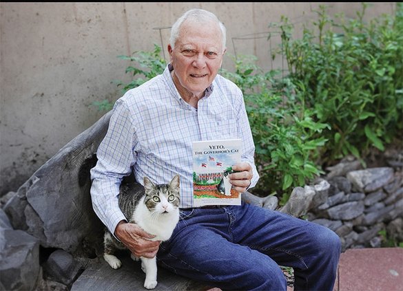 Former Georgia Gov. Nathan Deal shows off his children's book "Veto, The Governor's Cat," along with his real-life rescue cat, Veto.