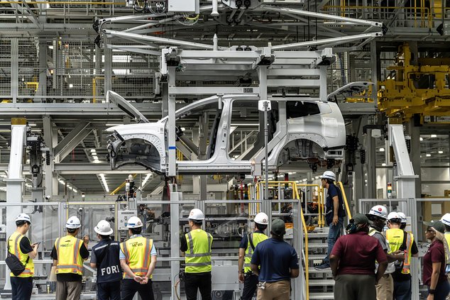 Hyundai Motor Group Metaplant America employees watch as a pre-production IONIQ 9 makes its way through general assembly at the Ellabell plant earlier in November.