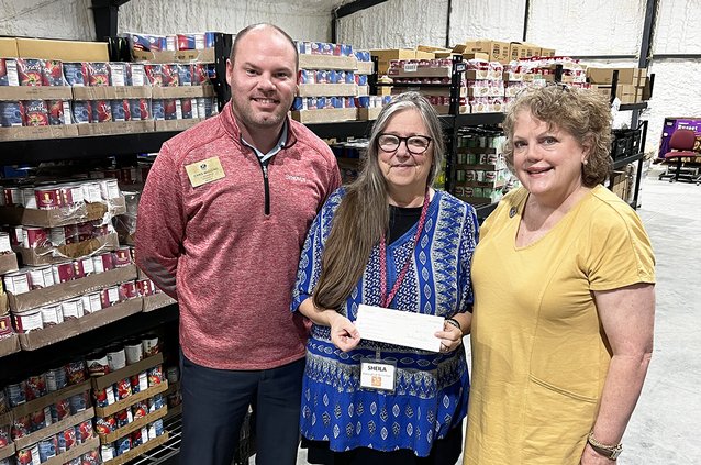 Sheila Stewart-Leach,  executive director of the Statesboro Food Bank,, accepts a donation from  Marilyn Darrell, president of the Kiwanis Club of Statesboro, and Kiwanis Club member Chris Wiggins, who also is the Division 17 Lt. Governor.