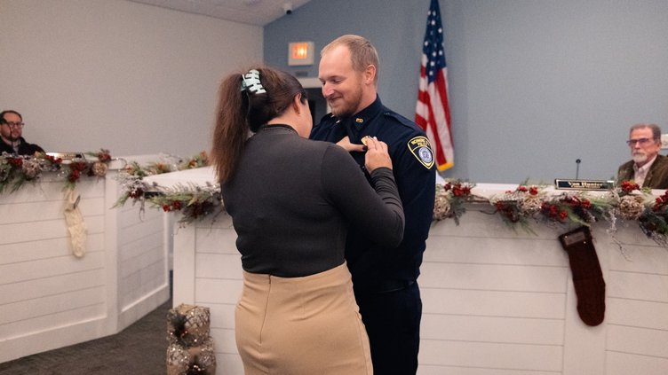 Sargeant David Royer receiving the pin from his wife, Kim.