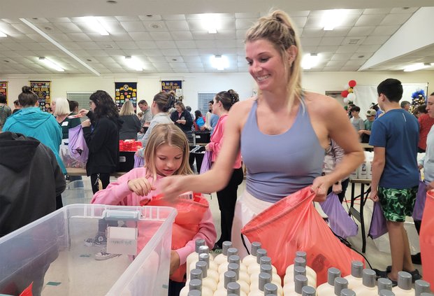 Kandace Sweat and her daughter, Sailor Hitt, 9, put together a package of hygiene products.
