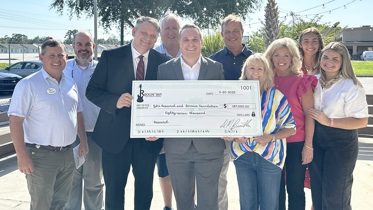 Dr. Nick Siekirk, center, holding check, from Georgia Southern University is pictured with members of his team and the Rockin' Out Alzheimer's Disease Foundation Board that recently awarded an $87,000 grant to GS for research led by Sr. Siekirk.