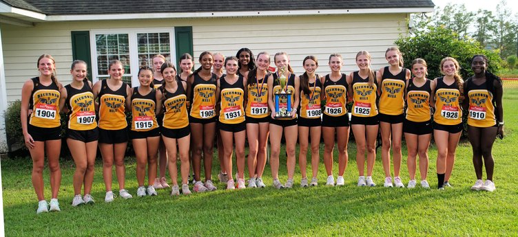 Lady Wildcats cross-county team and their 1st Place trophy.