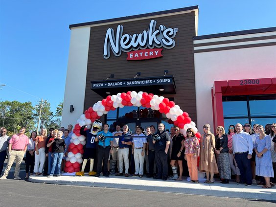Rick Howard, center, holding scissors, the principal owner of Newk's on Highway 80 East, officially opens the restaurant Wednesday along with GS mascot Gus, eatery manager Ron Flott, next to Gus, and Howard's business partner Tiko Shroff.